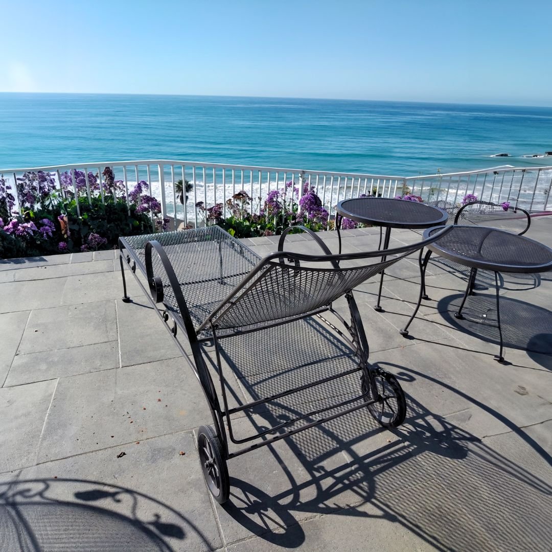 Vintage Metal Outdoor Chaise Lounge by ocean in Newport beach after restoration by patio guys