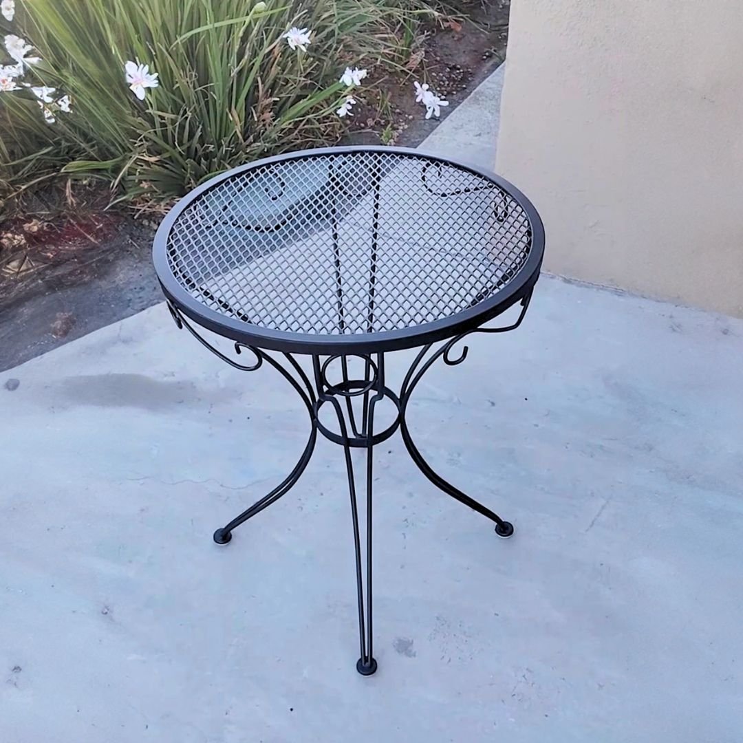 Ornate black metal outdoor side table restored by patio guys