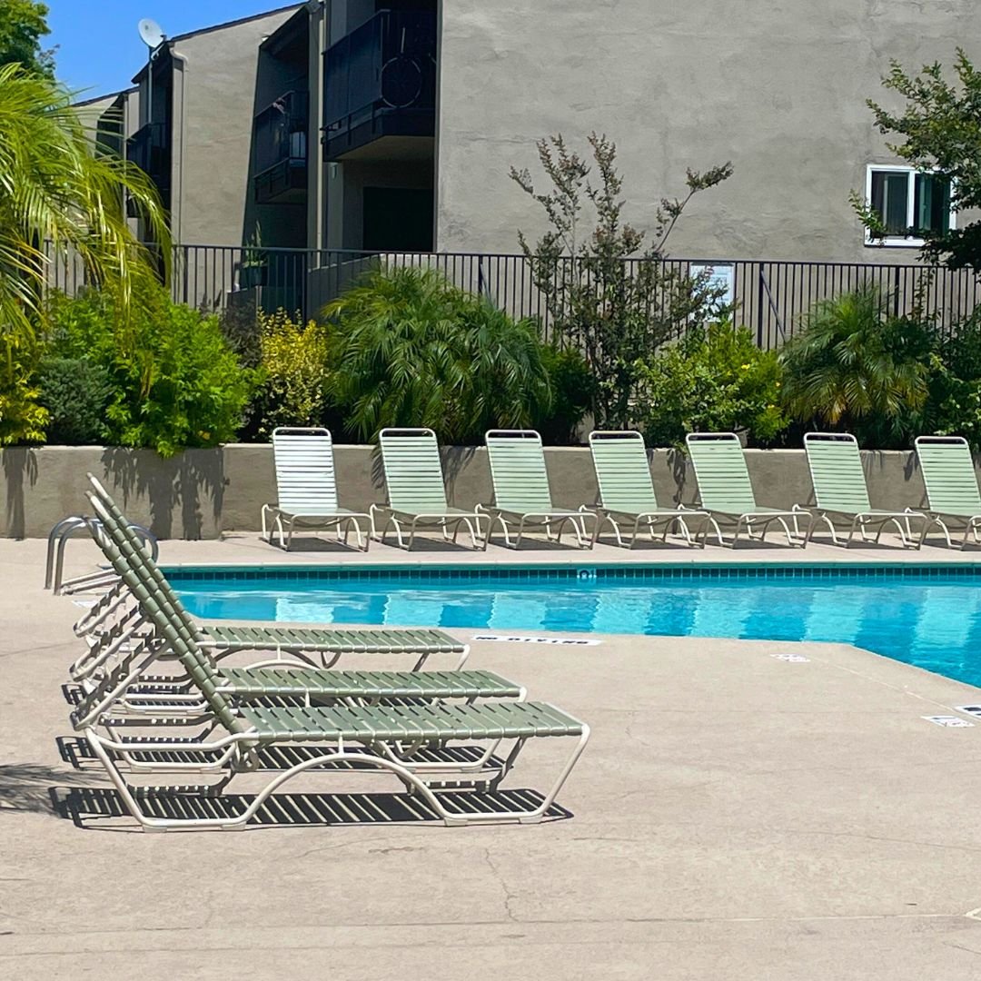 10 Commercial Chaise lounges with green vinyl strap beside hotel or HOA pool after being restored by Patio Guys Outdoor Furniture Refinishers