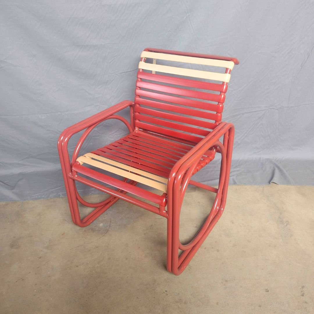 Unique, colorful patio chair whose arms and legs for a square. Repainted red and restrapped with red vinyl strapping and 4 white accent straps 