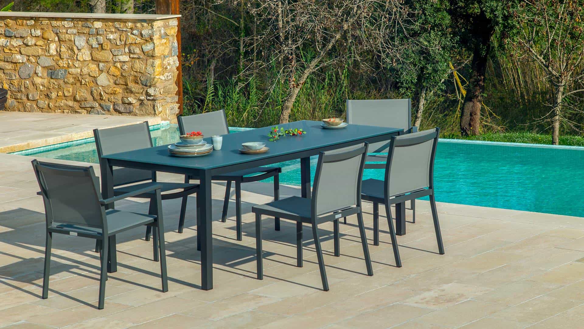 Outdoor dining set next to pool