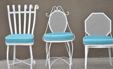 Light blue Sunbrella cushions on white wrought iron chairs