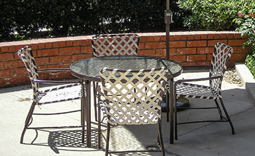 Four Tami Ami chairs around a circular acrylic table