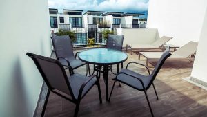 Acylic table and sling chairs on a condo balcony