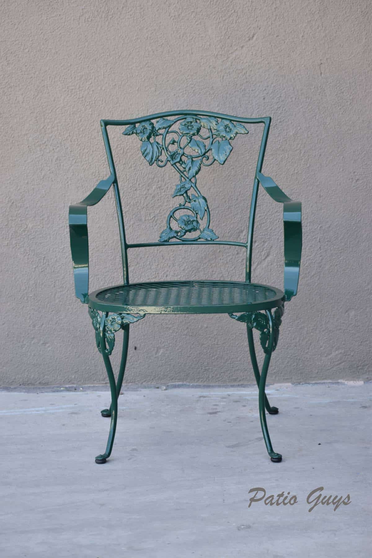 Dark green decorative garden chair with floral detail