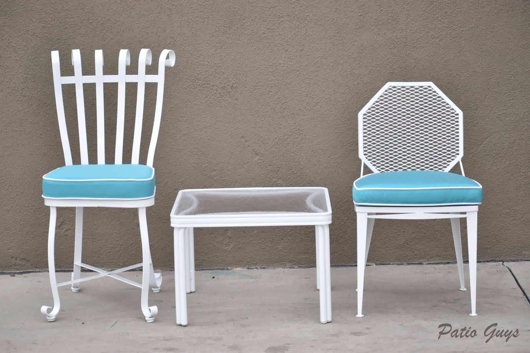 light blue cushions on white garden chairs with a side table