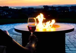 Romantic Patio Design Fire place with man drinking wine