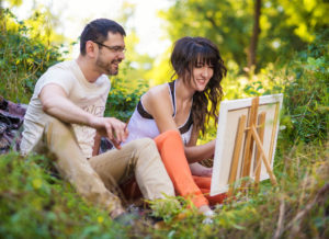 Couple painting together backyard date idea