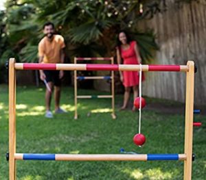 Couple playing ladder ball on backyard date